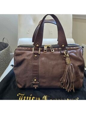 Juicy Couture brown/taupe leather satchel, featuring stud details and a tassel.